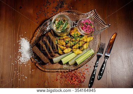 Top View Of Plate With Fried Potatoes With Pickled Mushrooms