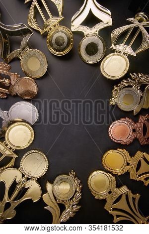 Golden trophy over blackboard background. top view. flat lay.Trophy is a specific achievement, serves as recognition / evidence of merit, awarded for sporting events