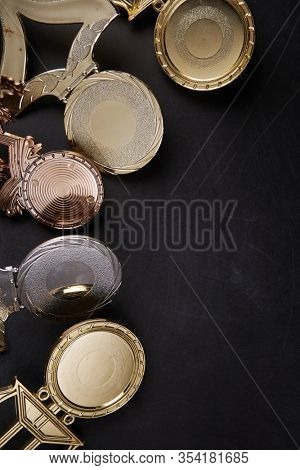 Golden trophy over blackboard background. top view. flat lay.Trophy is a specific achievement, serves as recognition / evidence of merit, awarded for sporting events