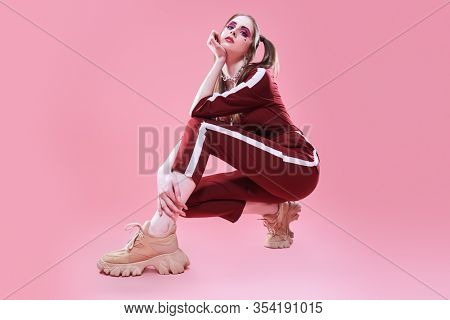 Fashion concept. Sport chic style. Full length portrait of a pretty girl in fashionable sportswear.