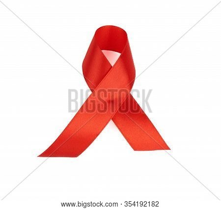 Red Silk Ribbon Folded Into A Loop And Isolated On A White Background. Symbol Of The Fight Against D