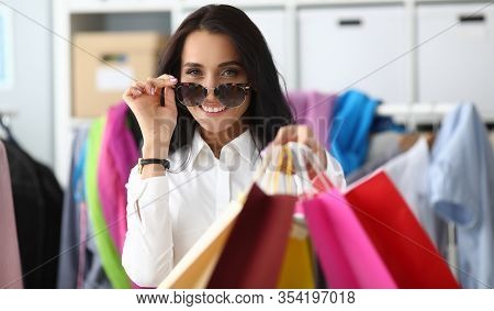 Woman Adjusts Glasses From Sun Showing Packages. Shopper Selectos Outfits For Client. Boutique Consu