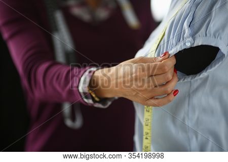 Tailor Measures Armhole Length On Mannequin Clothes. Experienced Seamstress Hand Hold Sleeve, Make M