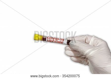 Coronavirus Covid-19 World Outbreak Concept With Vaccine Tag On Vacutainer. Female Chemist With Prot