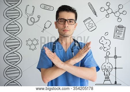 Doctor Showing Crossed Hands With Hand Drawn Medical Sketches. Medical Constraints Concept. Isolated