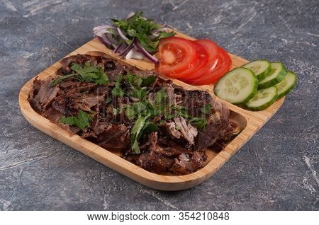 Turkish Doner With Veal, Cucumbers, Tomatoes And Onions On A Wooden Plate