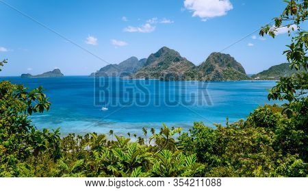 El Nido, Palawan, Philippines. Yacht Boat In The Sea Bay Near Las Cabanas Beach. Rocky Mountains In 