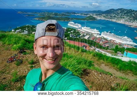 Three Cruise Ships In The Port Of St Thomas, Us Virgin Islands With Smiling Tourist Foreground