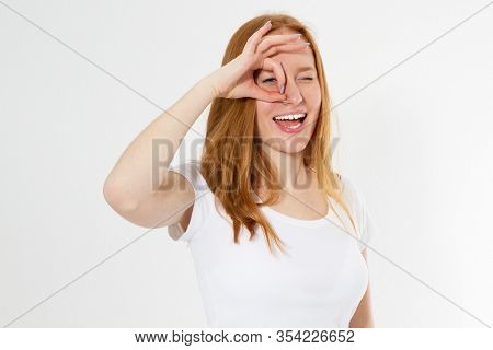 Red Head Girl In Colorful Clothing Holding Her Fingers Around The Eye Copy Space Isolated, Young Wom