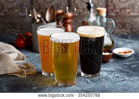 Assortment Of Beer In Tall Glasses Ina Rustic Setting