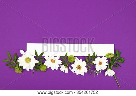 Background With White Flowers And Empty Notebook For Text On Purpule Table. Place For Text. Top View