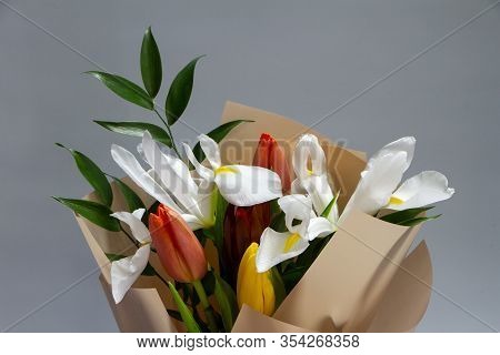 Detail Closeup Fresh Spring Bouquet Of Tulip, Iris, Ruscus On A Gray Background, Selective Focus