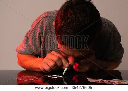 Junkie Man Inhaled Cocaine From The Table With Dollar. Social Disaster And Epidemic Of Narcotic Addi