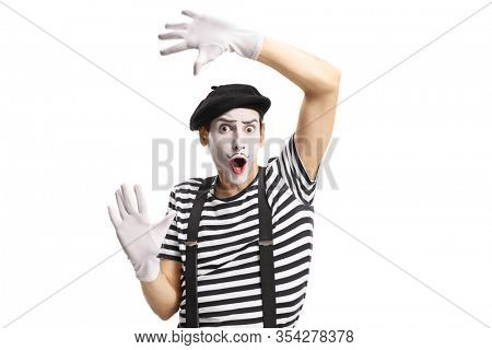 Mime toucing an imaginary wall isolated on white background