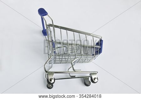 Shopping Concept : Empty Shopping Cart On Wheels On A White Background
