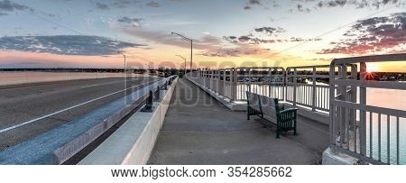 Bench View Of A Golden Sunset The Ss Jolley Bridge Into Marco Island, Florida.