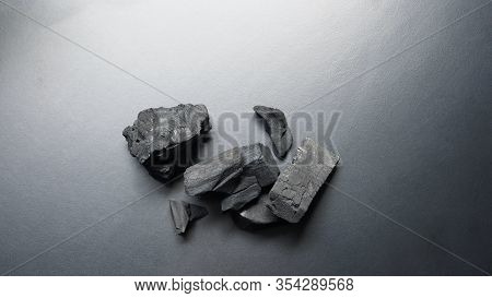 Black Wooden Charcoal On Black Background Top View