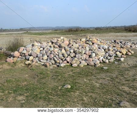 Group Of Stones In Ground Besides River Beas