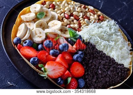 Asian Traditional Street Food: Bright Moon Pancake Or Martabak With Chocolate Chips, Peanuts, Strawb
