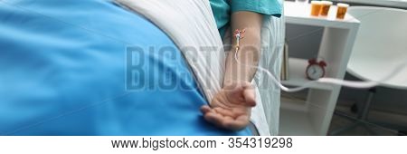 Fight For Life Concept. Hand Of A Young Man With A Dropper In Ward Of Medical Hospital. Lies After C