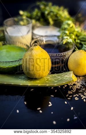 Face Mask For Acne And Blackheads On The Black Wooden Glossy Surface Consisting Of Some Cilantro Lea