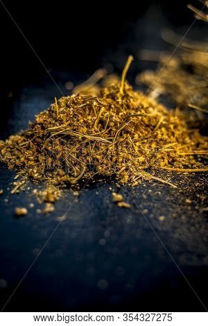 Close Up Of Shankhpushpi Roots On Wooden Surface Along With Some Of Its Powder With It. Shot With Bl