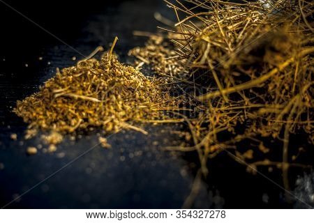Close Up Of Shankhpushpi Roots On Wooden Surface Along With Some Of Its Powder With It. Shot With Bl