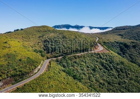 Country Asphalt Road Er209 Leading To Clouds Stuck At Mountain Hills In The Inland Of Madeira Island