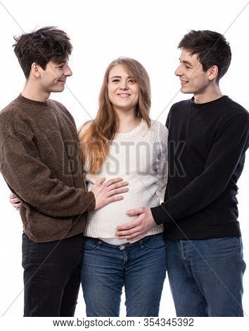 Young Pregnant Woman Posing With Two Young Man On A White Background