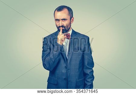 Mature Handsome Man Giving Shhhh Quiet, Silence, Secret Gesture. Closeup Portrait Of Mixed Race Bear