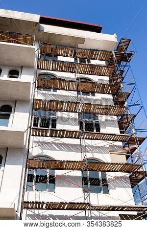 Extensive Scaffolding For Building A New House. Constraction Of Platforms For Building Works