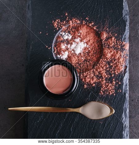 Beautiful Photo Of Pink Clay Skincare Product In Open Elegant Black Glass Jar Near Golden Spoon Fill