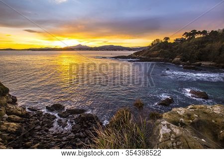 Playa De Los Frailes In The Orange Sunrise Of The Town Of Fuenterrabia. Basque Country