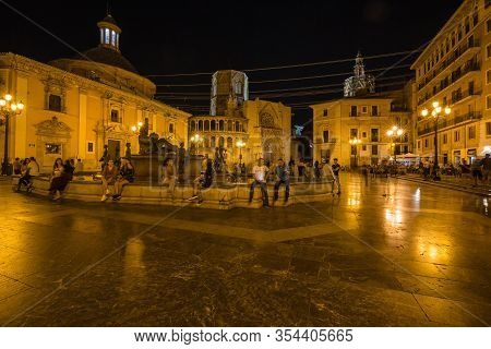 Valencia, Spain - October, 2019: Walking Night Streets Of Valencia Illuminated At Night. View Of Squ