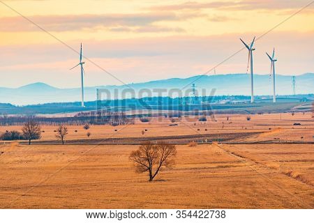 Wind Turbines On The Field In Rural Area. Ecology Concept