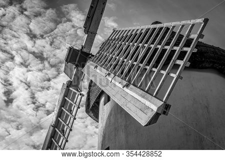 A Black And White Picture Of The Sailes Of An Old Windmill In Ireland