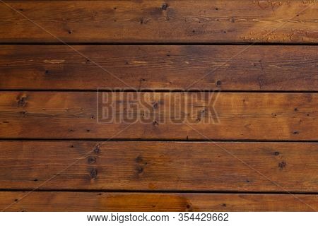 Stained wet deck wooden boards with water drops, brown planks texture
