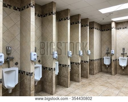 New Braunfels, Tx - 22 Feb 2020: Urinals And Hand Sanitizer Dispensers.