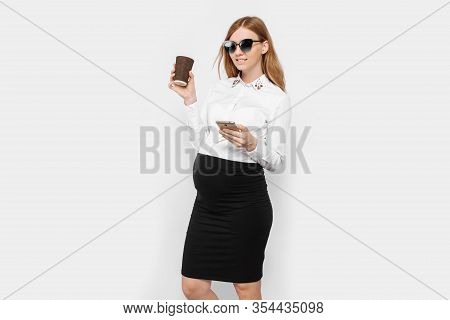 Image Of A Young Pregnant Businesswoman Wearing Glasses, A Girl Holding A Smartphone And Drinking Co