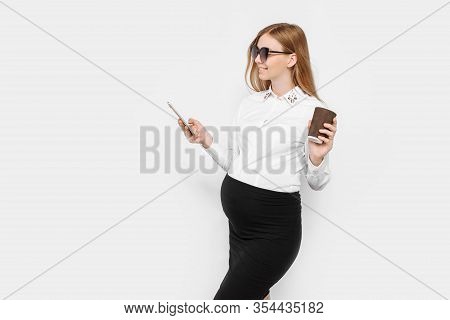 Image Of A Young Pregnant Businesswoman Wearing Glasses, A Girl Holding A Smartphone And Drinking Co