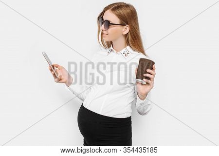 Image Of A Young Pregnant Businesswoman Wearing Glasses, A Girl Holding A Smartphone And Drinking Co