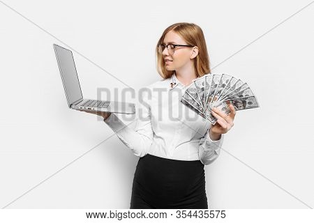 Image Of A Young Pregnant Businesswoman In Glasses Posing With A Laptop, Holding Banknotes In Her Ha