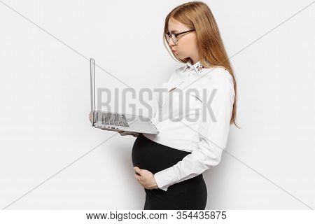 Image Of A Young Pregnant Businesswoman In Glasses Posing With A Laptop