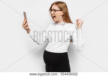 Image Of A Young Pregnant Business Woman With Glasses, Angry And Tired Girl Talking On The Phone And