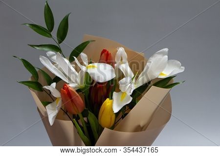 Detail Closeup Fresh Spring Bouquet Of Tulip, Iris, Ruscus On A Gray Background, Selective Focus