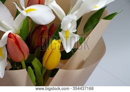 Detail Closeup Fresh Spring Bouquet Of Tulip, Iris, Ruscus On A Gray Background, Selective Focus