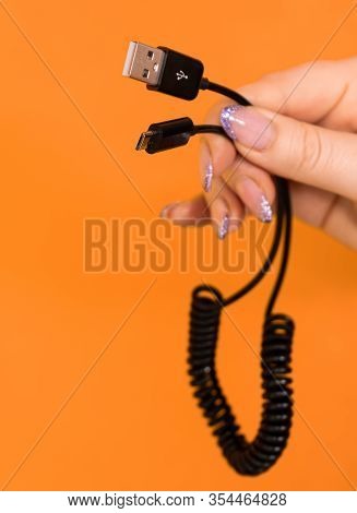Usb Computer Connector In A Girl's Hand On A Orange Background..