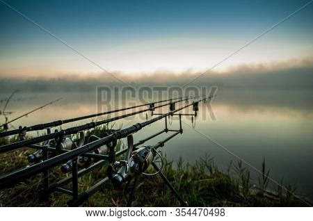Fishing Adventures, Carp Fishing. Angler, At Sunset, Is Fishing With Carp Fishing Technique.