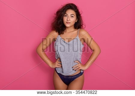 Beautiful Woman Wearing Blue Underwear And Gray Cotton T Shirt Standing Isolated Over Rose Studio Ba