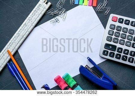Stationery Is Placed Around A White A4 Sheet Of Paper. Markers, Pencils, Pens, Calculator, Bookmarks